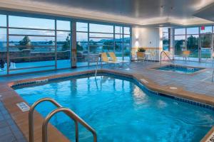 a pool in a hotel with a view of the water at Fairfield Inn & Suites by Marriott Scottsbluff in Scottsbluff