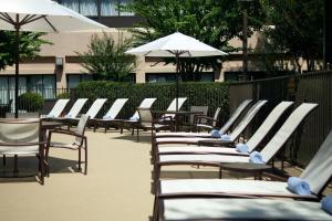 a row of chairs and umbrellas on a patio at Atlanta Marriott Peachtree Corners in Norcross
