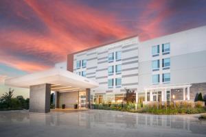 a rendering of a hospital building with a cloudy sky at SpringHill Suites by Marriott Kenosha in Kenosha