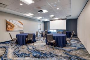 a conference room with tables and chairs and a whiteboard at Fairfield Inn & Suites by Marriott Charlotte Belmont in Belmont