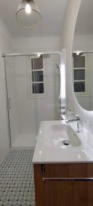 a white bathroom with a sink and a shower at LOS SUEÑOS DE BUENDÍA in Buendía