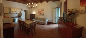 a kitchen and living room with a table and chairs at A Casa di Marti in Loreto