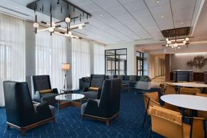 a lobby with couches and tables and chairs at Courtyard by Marriott Colorado Springs North, Air Force Academy in Colorado Springs