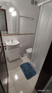 a bathroom with a shower and a toilet and a sink at Beach, surf and golf apartment near Lisbon in Aroeira