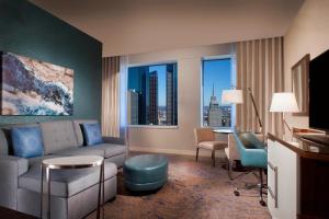 a living room with a couch and a room with a view at The Westin Dallas Downtown in Dallas