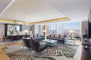 a living room with a couch and chairs and a table at Sheraton Manila Bay in Manila