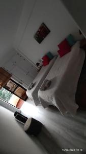 a bedroom with a bed and a room with a window at Beach, surf and golf apartment near Lisbon in Aroeira