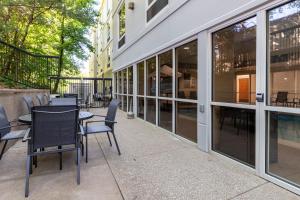 a patio with tables and chairs in front of a building at Fairfield Inn by Marriott Evansville West in Evansville