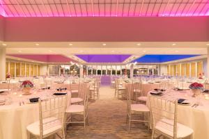 a banquet hall with white tables and chairs at Fairfield Inn & Suites by Marriott Chicago Schaumburg in Schaumburg