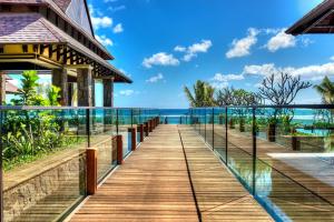 een houten loopbrug naar een huis met de oceaan op de achtergrond bij The Westin Turtle Bay Resort & Spa, Mauritius in Balaclava