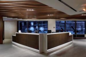 an office lobby with a reception desk with wood ceilings at SpringHill Suites Chicago Downtown/River North in Chicago