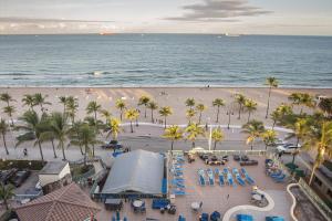 an aerial view of a beach with palm trees and the ocean at Courtyard by Marriott Fort Lauderdale Beach in Fort Lauderdale