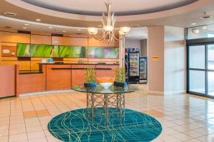 a lobby with a table with potted plants on it at SpringHill Suites Prince Frederick in Prince Frederick