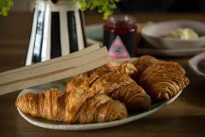 a plate of croissants and pastries on a table at The Artist's House at Jupiter Artland in Kirknewton