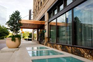 a building with a pool in front of a building at The Barfield, Autograph Collection in Amarillo