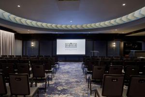 a conference room with chairs and a projection screen at The Barfield, Autograph Collection in Amarillo
