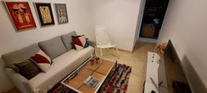 a living room with a couch and a table at LA CASITA DE LA PUERTA DE CARMONA in Seville