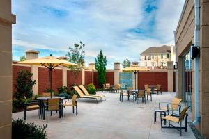 a patio with tables and chairs and umbrellas at Courtyard by Marriott Philadelphia Lansdale in Lansdale