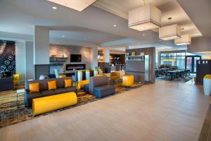 a living room with yellow and blue furniture in a building at Courtyard by Marriott Philadelphia Lansdale in Lansdale