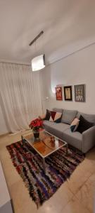 a living room with a couch and a coffee table at LA CASITA DE LA PUERTA DE CARMONA in Seville