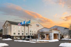 a hotel with two flags on top of it at Fairfield Inn and Suites by Marriott Plainville in Plainville