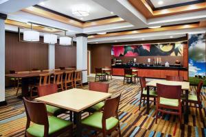 a restaurant with tables and chairs and a bar at Fairfield Inn and Suites by Marriott Plainville in Plainville