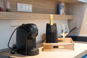 a bottle of wine and a wine glass on a counter at Giada Luxury Terrasini in Terrasini