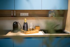 a kitchen counter with a sink and a bottle of wine at Giada Luxury Terrasini in Terrasini