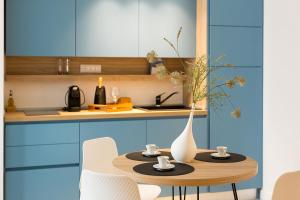 a kitchen with a table with cups and a vase on it at Giada Luxury Terrasini in Terrasini +138 photos