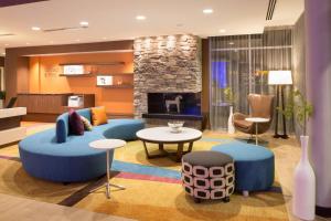 sala de estar con sofá y chimenea en Fairfield Inn & Suites by Marriott Burlington en Burlington