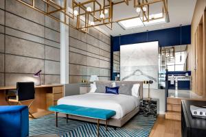 a bedroom with a king sized bed and a desk at W Montreal in Montreal