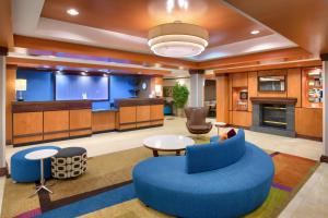 a lobby with a blue couch and a table at Fairfield Inn & Suites Richfield in Richfield