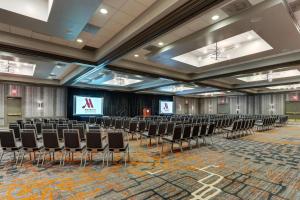 a conference room with chairs and a projection screen at Huntsville Marriott at the Space & Rocket Center in Huntsville