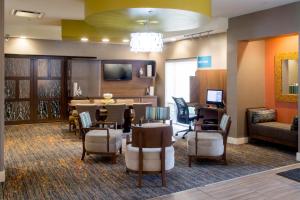 a lobby with a waiting room with a table and chairs at TownePlace Suites by Marriott Oxford in Oxford