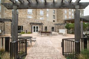 a patio with tables and chairs in front of a building at TownePlace Suites by Marriott Oxford in Oxford