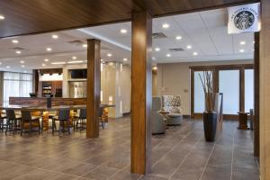 a lobby with a table and chairs and a kitchen at Courtyard by Marriott St. Joseph-Benton Harbor in Benton Harbor