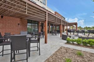 a patio with tables and chairs in a building at Courtyard by Marriott St. Joseph-Benton Harbor in Benton Harbor