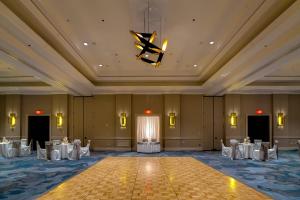 a ballroom with tables and chairs and a chandelier at Richmond Marriott Short Pump in Short Pump