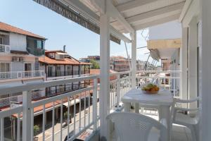 a balcony with a table and chairs on a building at Fani Guesthouse in Paralia Katerinis