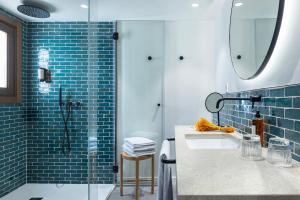a bathroom with a sink and a glass shower at Samaritana Suites in Palma de Mallorca
