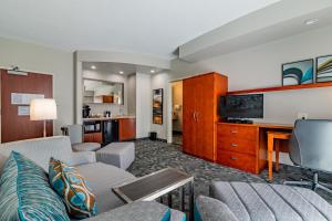 a living room with a couch and a tv at Courtyard Brunswick in Brunswick