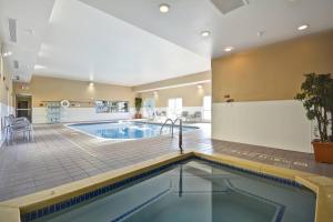 a pool in a large room with a swimming pool at TownePlace Suites Sioux Falls in Sioux Falls