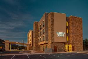 a building with a parking lot in front of it at Fairfield Inn & Suites by Marriott Flagstaff East in Flagstaff