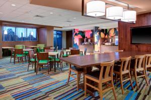a dining room with a large table and chairs at Fairfield Inn & Suites by Marriott Flagstaff East in Flagstaff