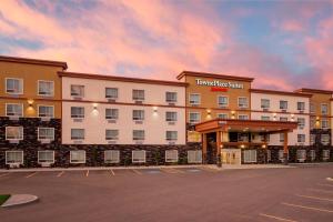 a rendering of the front of a hotel with a parking lot at TownePlace Suites by Marriott Red Deer in Red Deer
