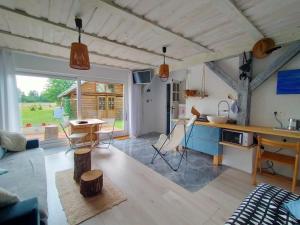 a kitchen and living room of a house with a table at Apartamenty na wsi Horses&Relax in Młynary