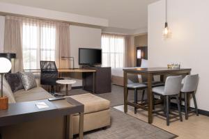 a living room with a couch and a table at Residence Inn Salt Lake City Airport in Salt Lake City