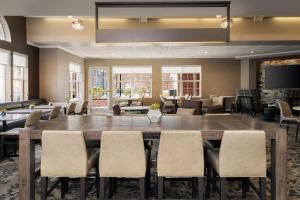 a large conference room with a large table and chairs at Residence Inn Salt Lake City Airport in Salt Lake City