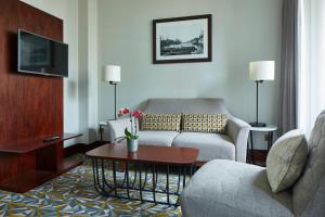 a living room with a couch and a table at Manchester Marriott Victoria & Albert Hotel in Manchester