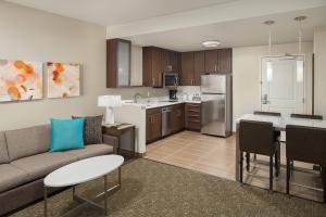 a living room with a couch and a kitchen at Residence Inn by Marriott Ontario Rancho Cucamonga in Rancho Cucamonga
